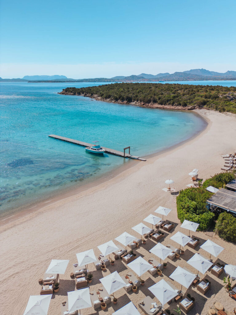 Drone shot of the sea and beach with several sun loungers