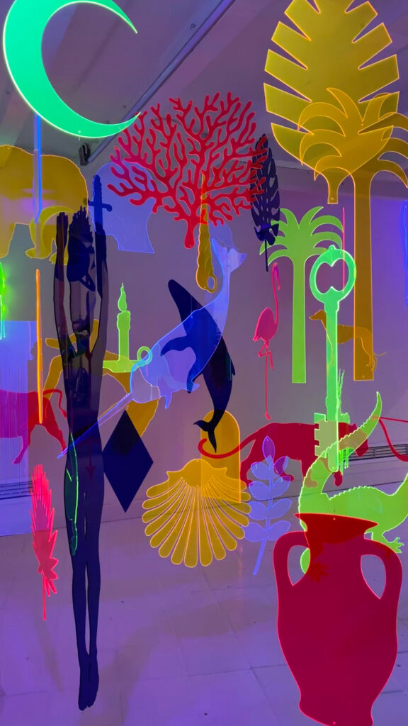 Colourful art hanging from the ceiling in the shape of animals and plants