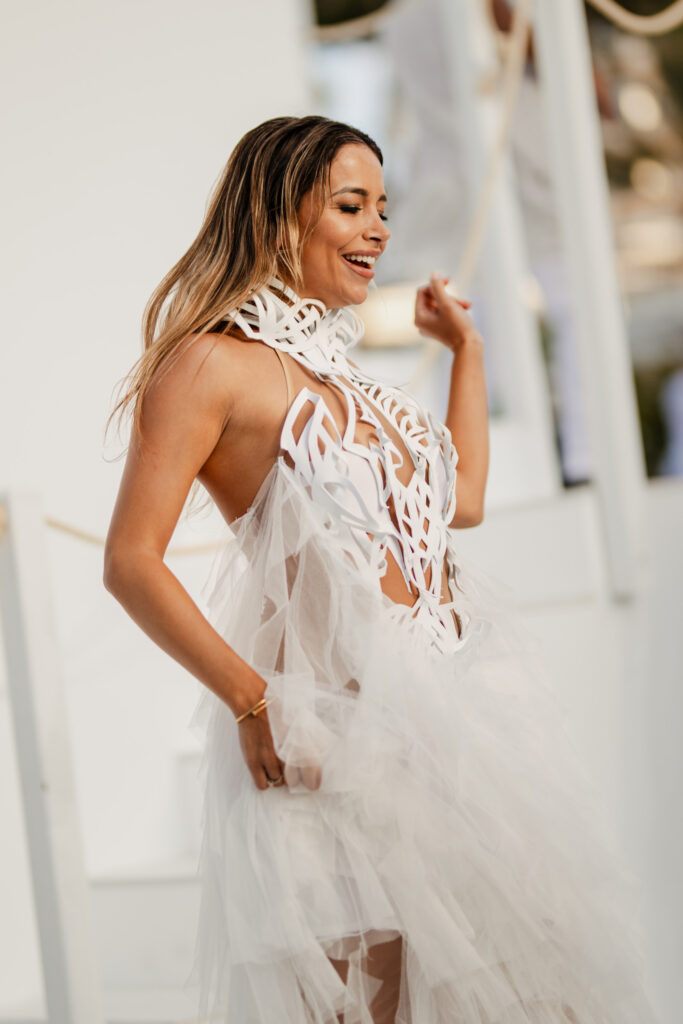 Lady dressed in white, dancing at the white party