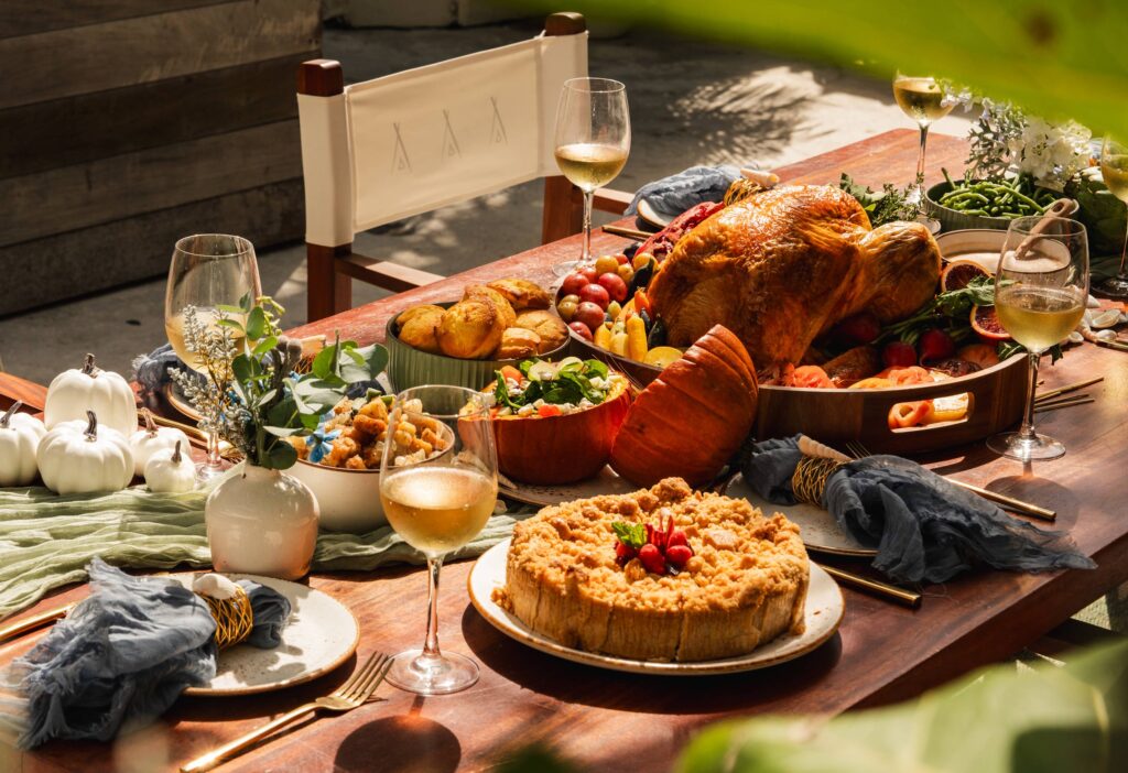 Banquet of food served at a Nikki Beach Table with glasses of white wine
