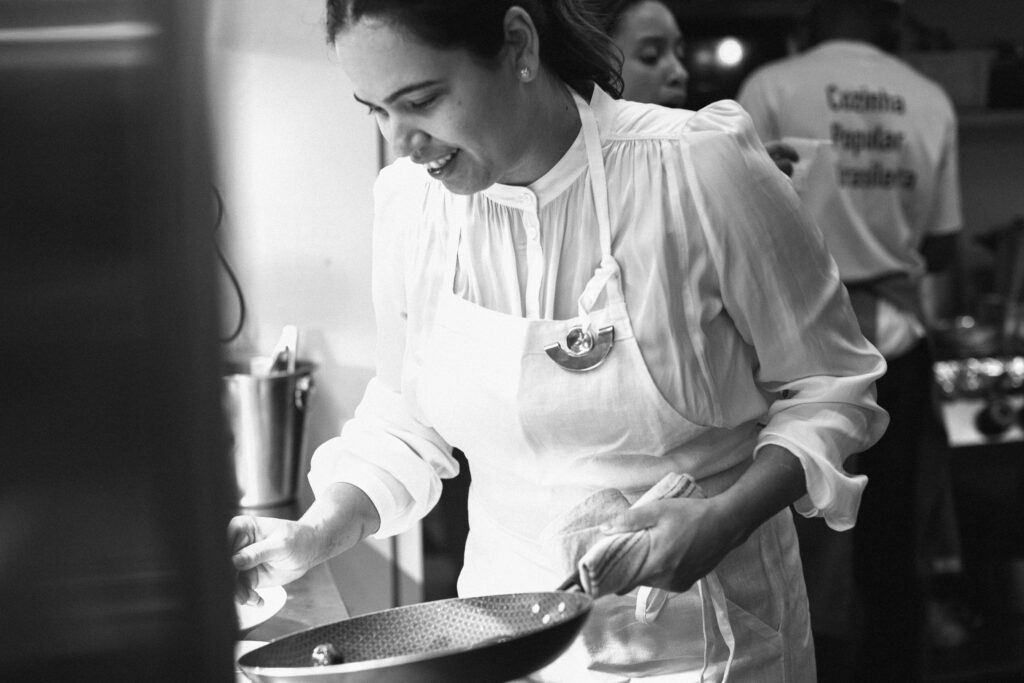 Chef Manuelle Ferraz cooking in a frying pan