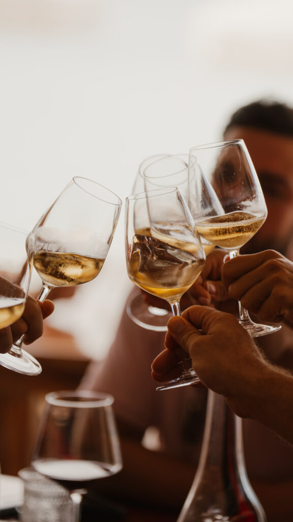 Group of people cheersing wine glasses