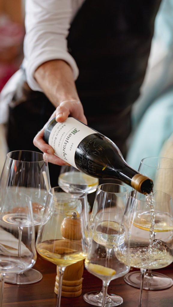 Waiter pouring a glass of wine